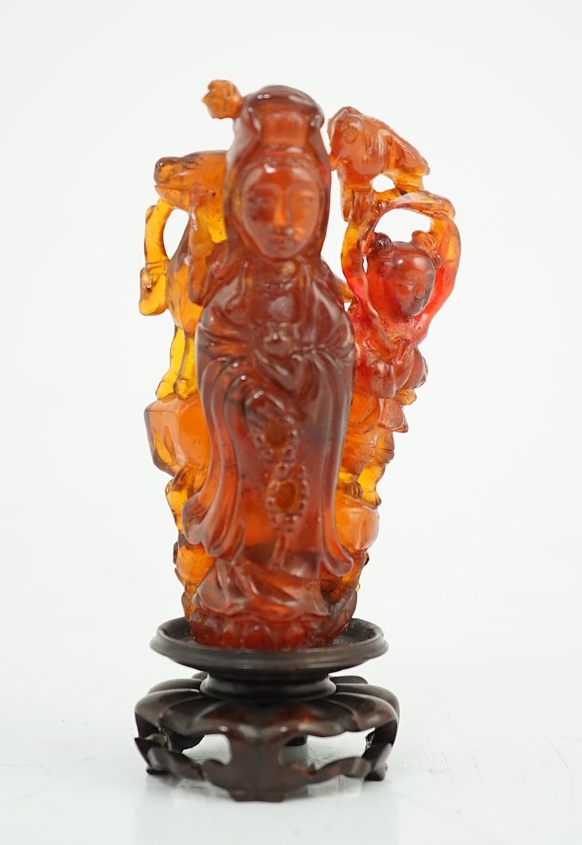 A Chinese amber group of Guanyin, 19th century, small losses